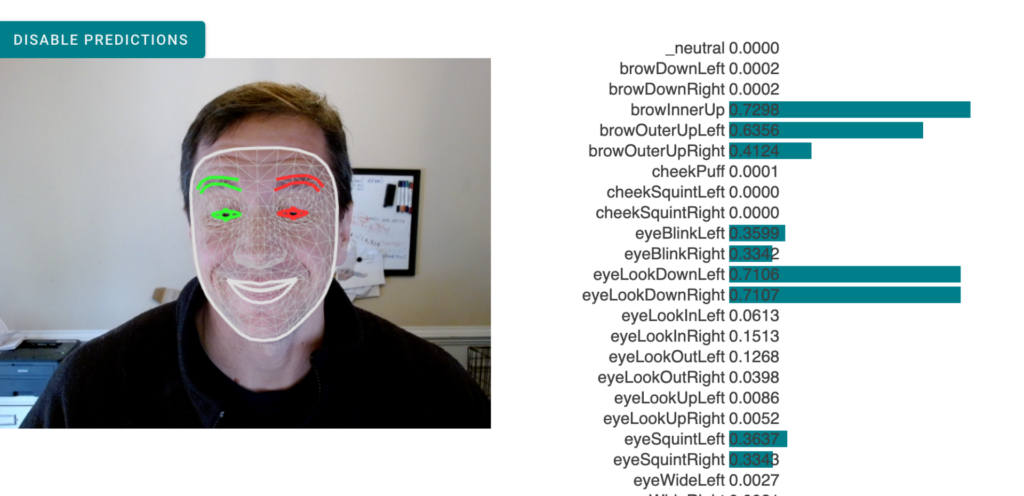 A facial recognition analysis interface displaying a man smiling with an overlaid facial mesh. The image includes colored markers on the face indicating detected expressions and facial movements. The right side of the image contains a list of facial expression parameters with numerical values, such as "browInnerUp 0.7298" and "eyeLookDownRight 0.7107," visualized as horizontal bars. The interface has a "DISABLE PREDICTIONS" button at the top left. The background shows an office setting with a whiteboard, a printer, and some notes pinned to the wall.